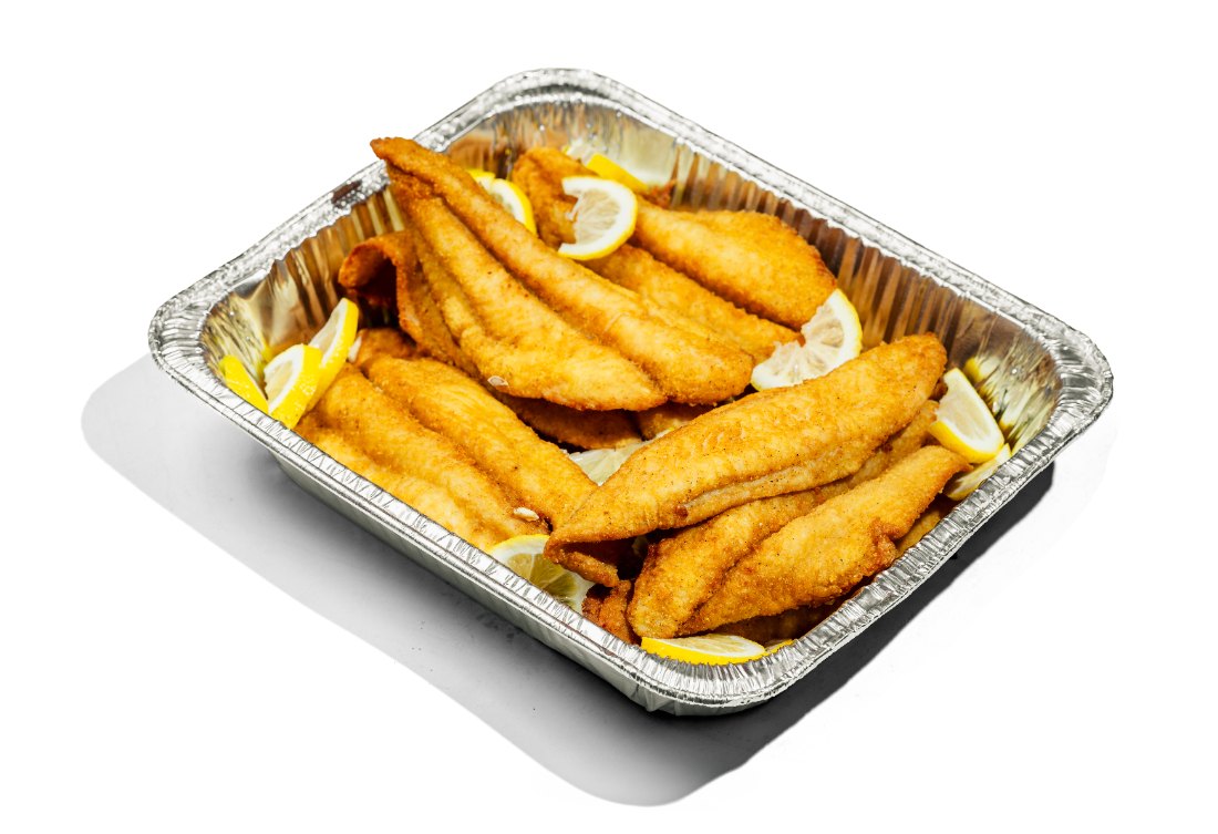 Tray of fried fish fillets with lemon
